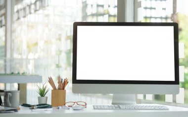 Mock up computer with empty screen on white table.