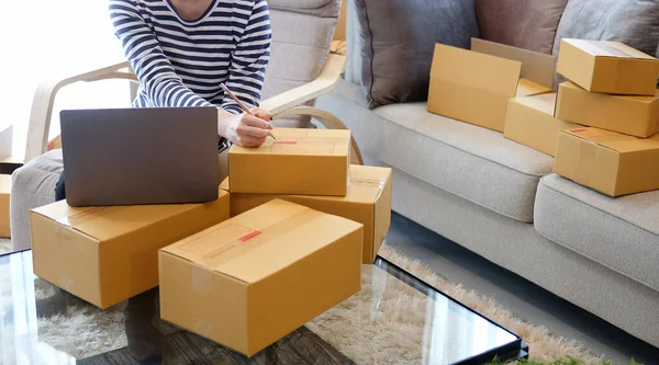 Startup Small Business Owner Using Laptop Computer Writing Address Cardboard — Φωτογραφία Αρχείου