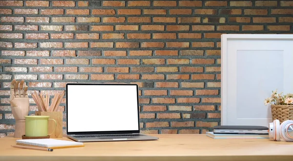 Mock Computer Laptop Supplies Empty Frame Wooden Table Brick Wall — Zdjęcie stockowe