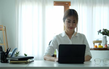 Modern ofiste bilgisayar tableti ile çalışan güzel bir yaratıcı tasarımcı..