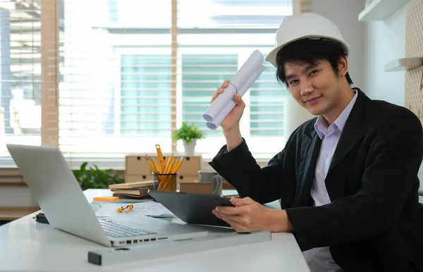 Young Asian Engineer Formal Suit Hardhat Rolled Blueprints Sitting Workplace — Stock Photo, Image