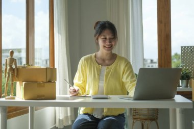 Small business entrepreneur using laptop computer, checking order from customer. Startup small business, Online selling, E-commerce concept.	