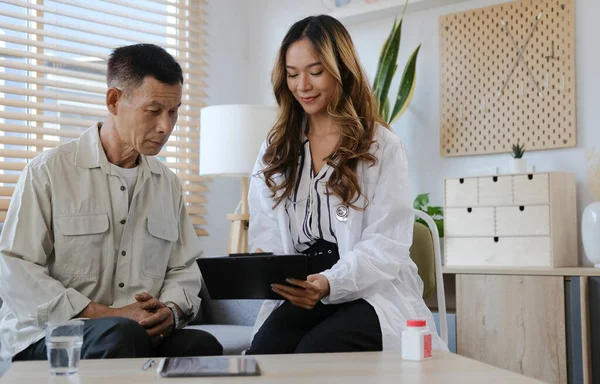 Charming female doctor giving advice to old male patient. Medical healthcare concept.