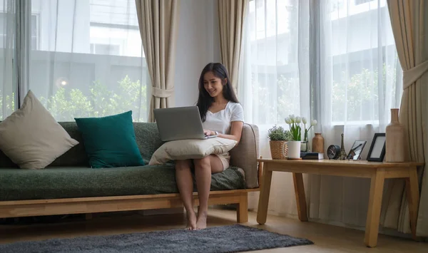 Happy Young Woman Sitting Couch Living Room Using Laptop Computer — стоковое фото