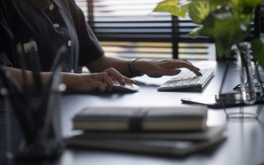 Close up view woman hands typing on computer.	