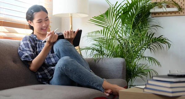 Smiling Young Woman Sitting Couch Working Digital Tablet — Stockfoto