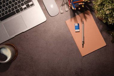 Top view simple workplace with laptop computer, coffee cup, and potted plant on wooden background.	