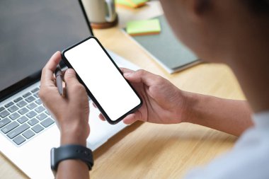 Close up view of man holding mock up smart phone with blank screen.	