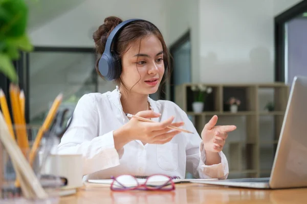 Confident Female Freelancer Wearing Headphones Talking Video Call Colleague Business — Foto Stock