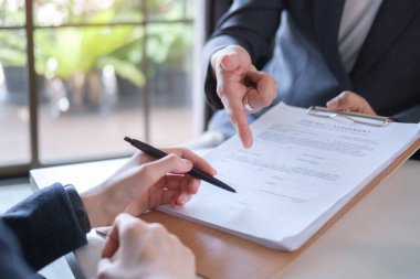Lawyer with agreement document to customer for signing. Legal services, advice, justice and law concept.