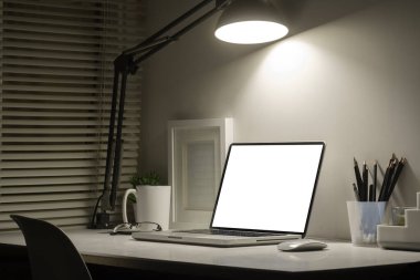 Bilgisayarı, resim çerçevesi ve kırtasiyesi olan ofis masası. Reklam metniniz için boş ekran.