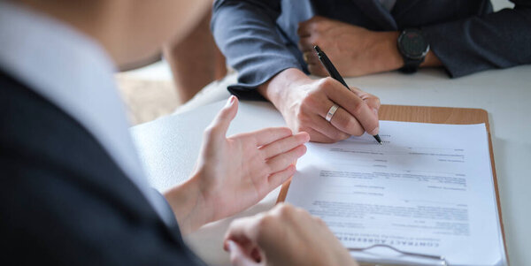 Shot of lawyer giving consultation to client, explaining legal procedures and discussing agreement terms. 