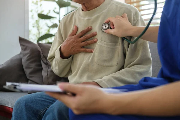 Young Male Doctor White Uniform Holding Stethoscope Examining Senior Patient — Fotografia de Stock