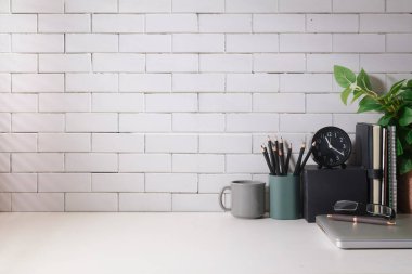 Creative workplace with books, coffee cup, pencil holder and laptop. Home office desk, Copy space for your text.