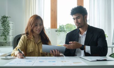Two professional business colleagues have working, discuss business ideas together.