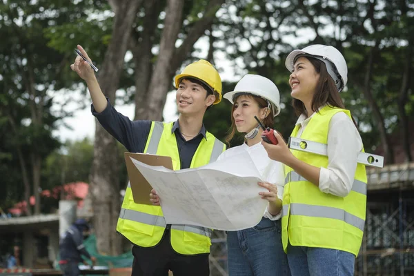 Architect and engineer team discussing the structure of the building with architects at construction site.