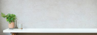 Home office desk, minimal workplace with potted plant, cup of coffee and notebook.