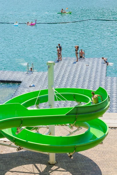 Lake Bled, Slovenia - August 20, 2018: Visitors enjoy the fresh turquoise waters in the swimming pool and water slides area.