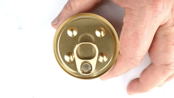Hand opens metallic tin can of canned cats or dogs preserve. Lifts the metal cover. Healthy animal food concept. Top view. Close-up. — Stock Video
