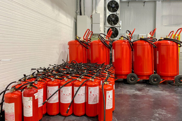 Kiev, Ukraine, July 2021: - A lot of fire extinguishers. Protection and security in case of fire. Industrial background. Close-up.