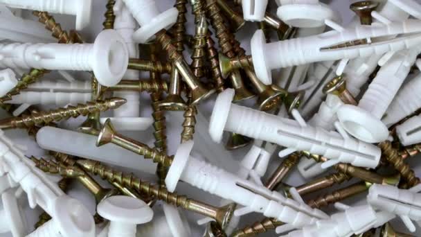 Bunch of tapping construction screws with plastic dowels for fixture rotate clockwise. — Stock Video
