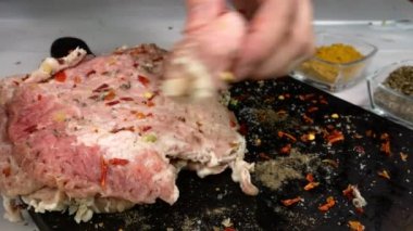 Cook wrap meat rolls of fresh raw pork fillet on kitchen board cooking tasty food.