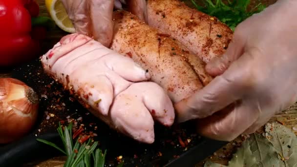 Chef rubbing piece of pork legs with savoury spices and seasoning for roasting. — Αρχείο Βίντεο