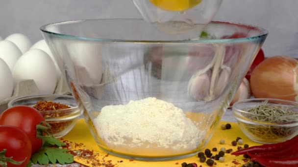 Chef pouring oat flakes, eggs, flour, corn groats and chopped green into glass bowl and whisking. — Stock Video