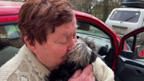Senior Adult Woman Returning Immigration Hugs Cuddles Her Brussels Griffon — Stock Video