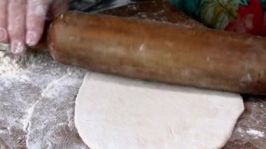 Chef make meat pies kutaba or chebureki, raw minced meat with onions and herbs filling dough. Preparation tasty fast food on domestic kitchen. Close up.