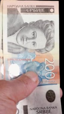 Hands counting stack cash Serbian dinar different cost, recalculation banknotes. Parsimony, savings, home finance. Vertical. Close up.