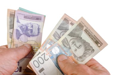 Hands counting stack cash Serbian dinar different cost, recalculation banknotes. Parsimony, savings, home finance. Isolated on white. Close up.