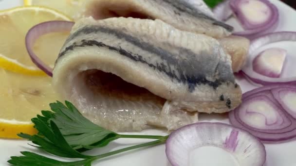 Tasty Salted Herring Fish Fillet Onion Rings Lemon Parsley Rotate — Stock video