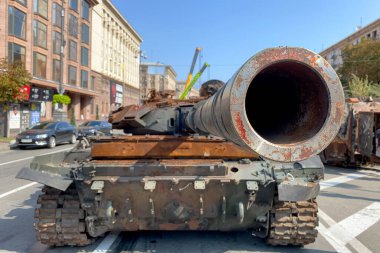 Russian battle tank knocked and destroyed during war Ukraine against Russian aggression are showing to people, on Khreshchatyk in Kyiv. Selective focus. Close up.