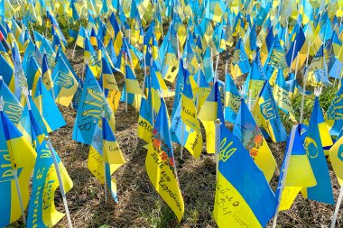 Kyiv, Ukraine, August 2022: - Lots national flags of ukraine with names of killed soldiers in war against Russian aggressors 2022 on Khreshchatyk street. One flag with name - one hero. Close up.