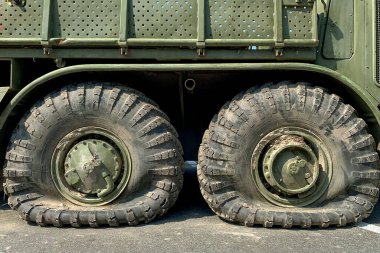 Kyiv, Ukraine, August 2022: - Flat tire on old military or truck vehicle. Road accident. Close up.