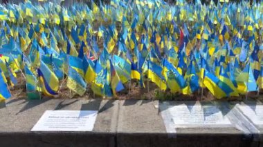 Kyiv, Ukraine, August 2022: - Lots national flags of ukraine with names of killed soldiers in war against Russian aggressors 2022 on Khreshchatyk street. One flag with name - one hero. Close up.