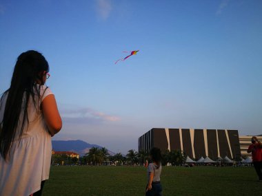 Kuala Lumpur, Malezya - 14 Eylül 2019: Küçük kızlar ve doğada uçan uçurtma