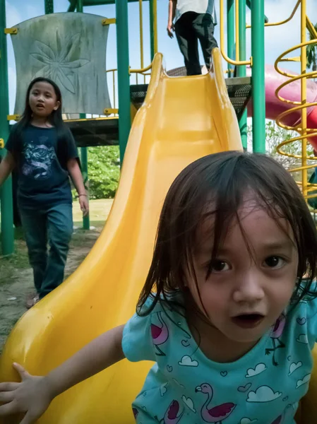 Children at the playground. Happy family in Malaysia.