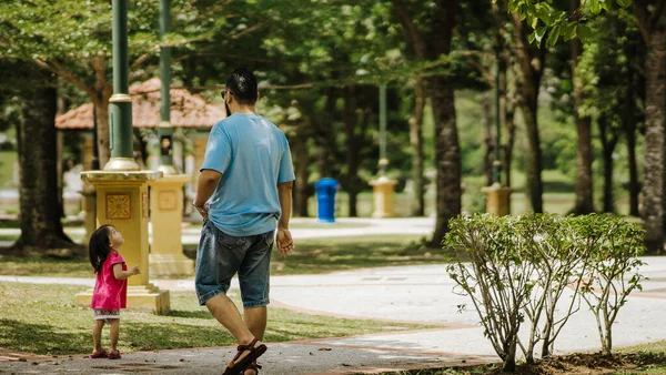 father and  his daughter in the park on nature background