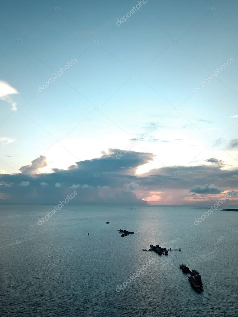 Aerial wide panorama of Bum Bum Island against an early morning blue sky colourful sunrise in Semporna, Borneo Sabah, Malaysia.