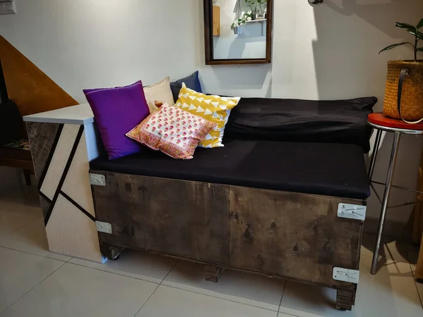 Kuala Lumpur, Malaysia - June 8, 2019: Big cargo wooden crate upcycled into a sofa to match the industrial interior design in an apartment.