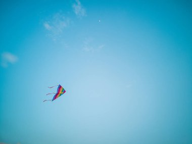 Renkli uçurtma rüzgar mavi gökyüzünde uçan.