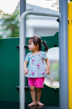 Küçük şirin Asyalı 2-3 yaşında, çocuk parkında küçük bir kız çocuğu. 