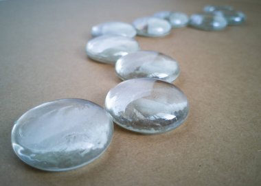 Kahverengi arkaplanda ışık yansımaları olan açık misketler.