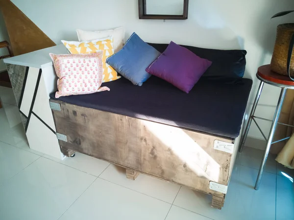 Kuala Lumpur, Malaysia - June 8, 2019: Big cargo wooden crate upcycled into a sofa to match the industrial interior design in an apartment.