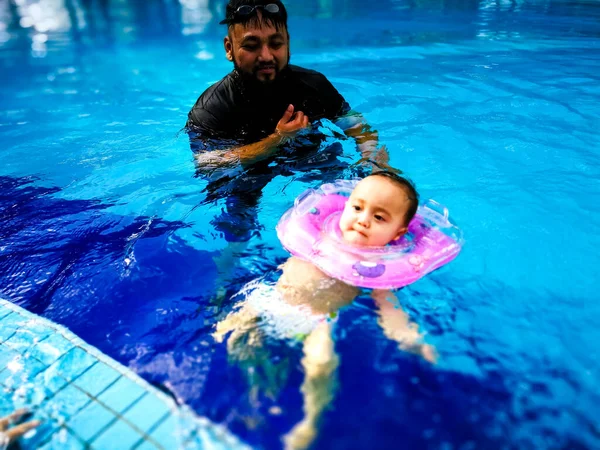 Father Looking Cute Little Baby Inflatable Neck Ring Swimming Pool — 图库照片