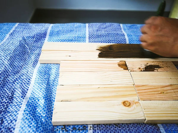 Hand Holding Brush Shows How Apply Brown Mahogany Stain Wood — Stockfoto