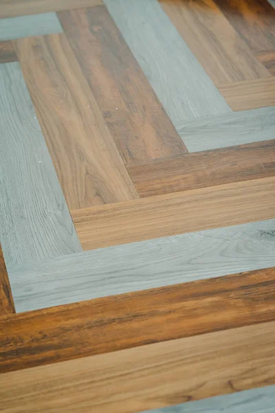 Herringbone PVC flooring with decoration. Multi-coloured luxury design.