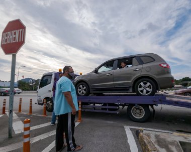 Perak, Malaysia - Aug 7, 2022 : Broken car on the truck with passenger to the workshop.